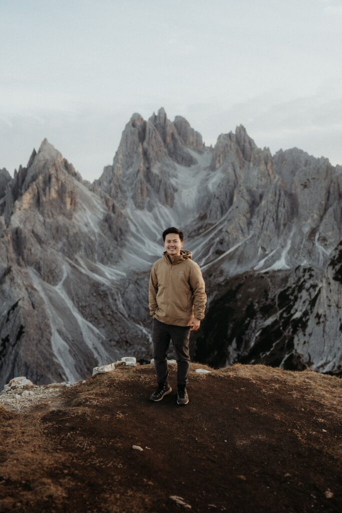 Dolomites elopement photographer standing on a mountain trail at Tre Cime.