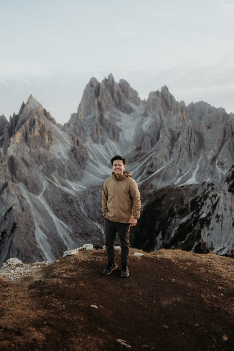 Dolomites elopement photographer standing on a mountain trail at Tre Cime.