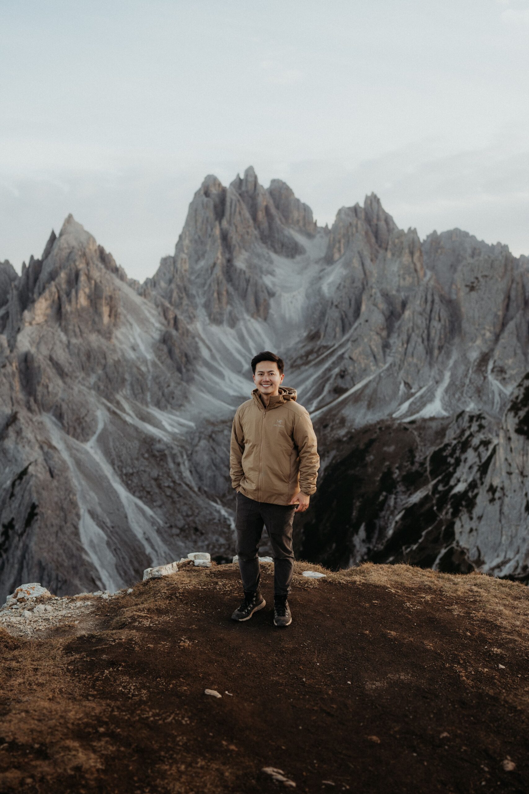 Dolomites elopement photographer standing on a mountain trail at Tre Cime.