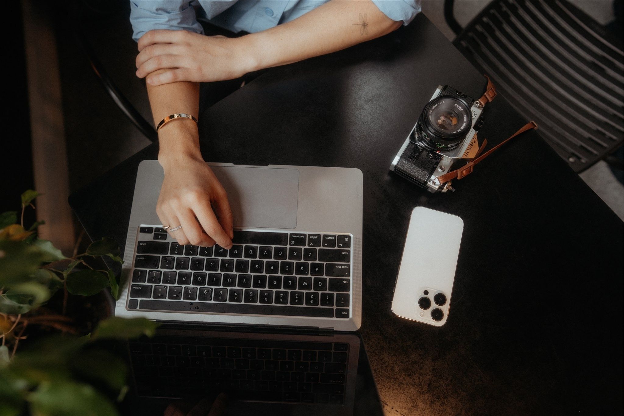 Woman resting her hands on her macbook computer.